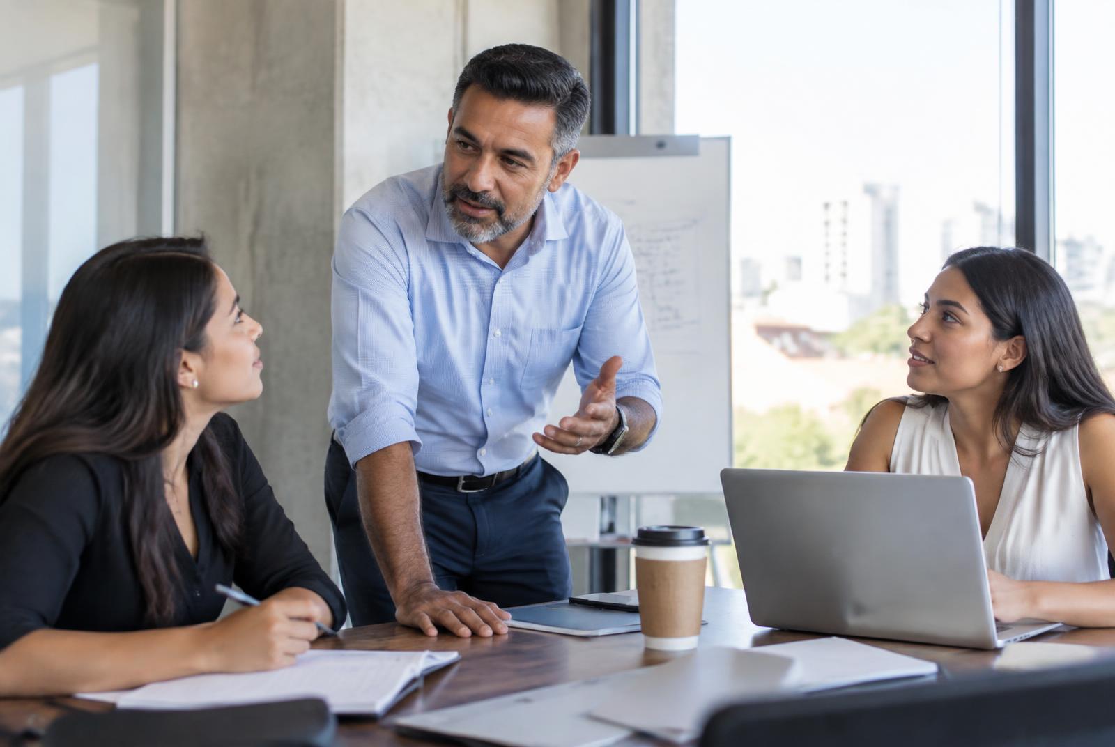 Latino mentor leading a professional training session in a bright meeting room